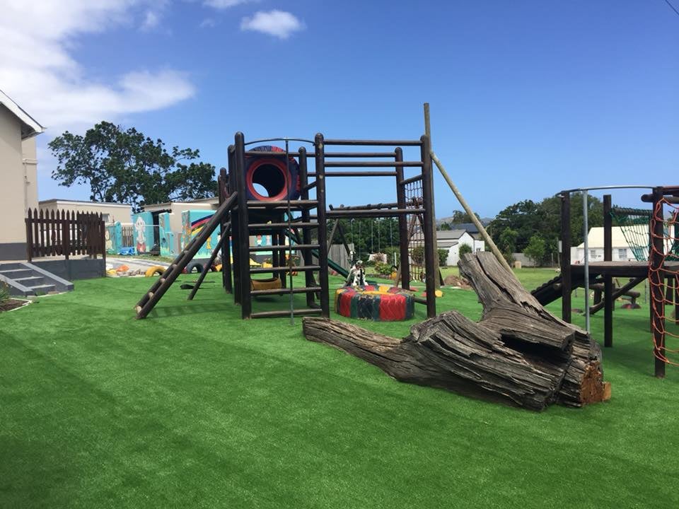 Children's playground installed over artificial grass