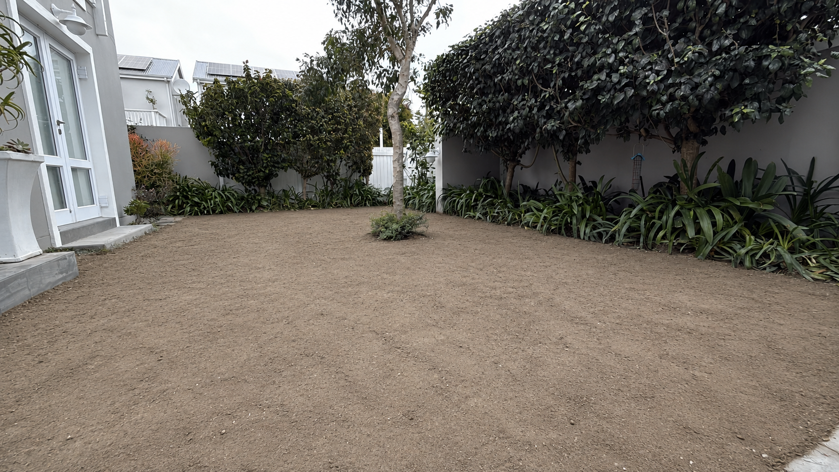 Prepared bare-soil backyard before the Knysna paving and artificial grass renovation